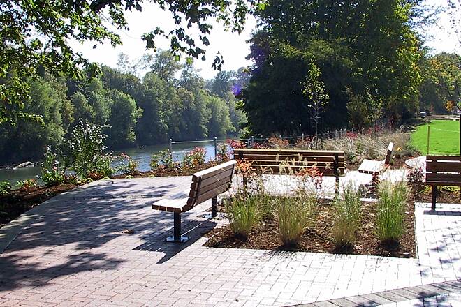 Corvallis riverfront promenade with trees and the Willamette River at golden hour